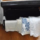 Black hassock; vintage linens.