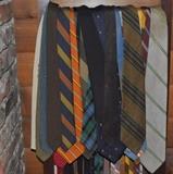 Lots of vintage men's ties on a nice wood hanging butler stand.
