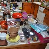 Lots of kitchen items -- Melamine, Le Creuset, cake pans, vases, pottery, Corning Ware, Pyrex. bean pots, cast iron, glass, pots and pans, copper, casserole dishes, china, pottery, plates, cups/saucers, etc.