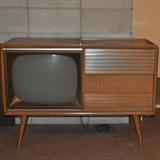 Atomic age mid-century Magnavox television/stereo in cabinet.