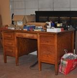 Large vintage oak desk, miscellaneous office supplies.