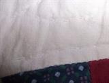 Note the stitching on the quilt