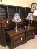 Queen air bed has head board and foot board with matching nightstands, dresser, and chest.