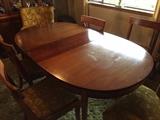 Solid wood dining room table with four side chairs and two upholstered captains chairs