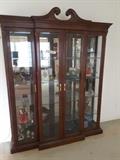 Breakfront over 8 foot table with 5 Glass Shelves, Doors open in the Middle and on Left and Right Sides. Decorative Collectible Figurines and Dishes.