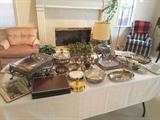 Collection of Silver plated Serving Bowls, Casserole Trays, Hot Pads with England Scenes, Plain. Pink Arm Chair, Lamp, Plaid Chair, Plaid Wool Blanket. Silver plated items are unpolished.