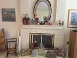 Oval Mirror, Small Rocking Chair from American 1978, German Nurnberger Kuchen/Cake Containers, Tall Candle stick holder, Glass Container, Collection of Christmas Santas, Dolls, Candles, Small Clock on the Mantel. Decorative Paintings.