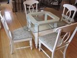 Glass topped table with four chairs by Broyhill.
