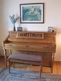 Upright piano with matching bench.