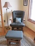 Glide rocker with matching footstool. Floor lamp. Rug.