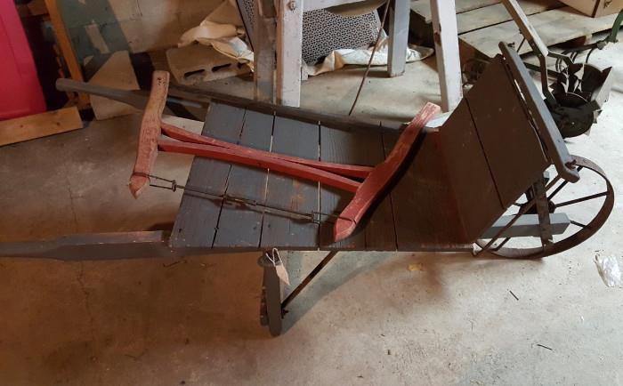 Not one, but TWO antique wheelbarrows. Plus other farming and gardening implements