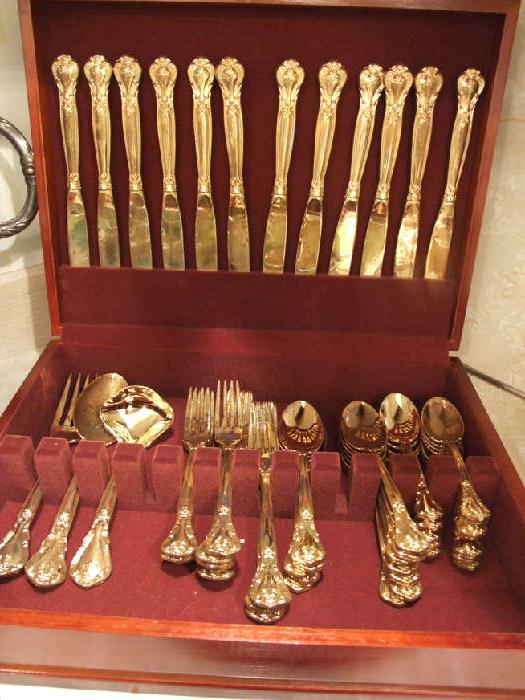 GOLD OVER SILVER FLATWARE SET IN BOX.
