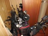 Assortment of golfing equipment including clubs, caddies, shoes...