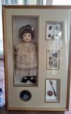 This is a doll fashioned after a little girl with her silver baby things.  