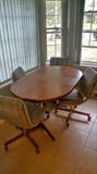 table with four chairs on rollers