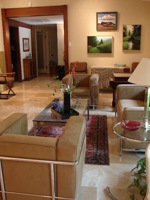 Cassina petit modele chairs and three seat sofa in fawn, other contemporary chairs, chrome and glass tables. Art by Brian Keeler (Pennsylvania) in background.