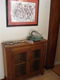 A small scale chest that is narrow enough to fit even the most narrow hallway., Example of the contemporary art found throughout the house. Green glass dish and swan.