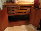 View of the interior of one of the two credenzas showing storage drawers
