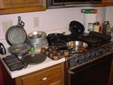 Lots of cast iron and metal kitchen ware.