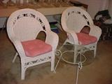 Matching wicker chairs and small glass top table.