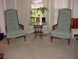 Matching high backed chairs. Very tight and very comfortable. The iron based glass top table is just the right size for the front window.