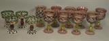 Lot 9:  Lot 13pc MACKENZIE CHILDS Hand painted Stem Glasses. Set of 9 Glasses with pink rose trellis design. Gold lustre highlights. Also set of 4 Glasses with bold gold dots design. Awning striped rims. : Dimensions:  H: 6.75 inches: W: 3.75 inches --- US Shipping charge: $50