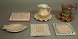 Lot 10:  Lot 8pc MACKENZIE CHILDS Hand painted Ceramics. One Mug & saucer 2001; Gold & platinum accents. Three tile trivets. One fish shaped dish. One creamer pitcher with ruffled plate. : Dimensions:  H: 6.5 inches: W: 7 inches --- US Shipping charge: $50