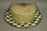 Lot 12:  MACKENZIE CHILDS Enamel Cake Carrier. Green marbleized cover on courtly check plate.  Metal hardware. : Dimensions:  H: 6.5 inches: W: 17 inches: D: 17 inches --- US Shipping charge: $35