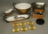 Lot 18:  MICHAEL ARAM Table Ware Lot. 1). Fig Salt & Pepper with Leaf Dish. Boxed. Coaster set in case. Three pieces Gold exterior serving pieces with black twig handles. Chrome & twig serving spoon.: Dimensions:  H: 7.25 inches: W: 13.25 inches --- US Shipping charge: $50