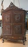 Lot 46:  Large Carved Crest Two Door Wardrobe Armoire. Door panels have relief carved heart designs. Large tall crest with carved floral details. Ball & Claw feet. Lower drawer: Dimensions:  H: 96.5 inches: W: 54.5 inches: D: 25 inches --- 
