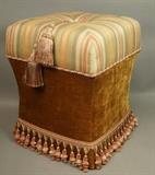 Lot 59:  Contemporary Decorator Pouf Stool. Upholstered bench  with lid is hinged to reveal storage. Stool Pigeons Inc. Made in USA. Tasseled fringe detail. : Dimensions:  H: 21 inches: W: 17 inches: D: 17 inches --- 