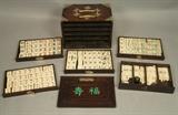 Lot 115:  Mah Jongg Tile Set In Dark Wood Box Case. Five interior drawers with game pieces. Metal trim & decorative elements. Green inlaid design.  : Dimensions:  H: 6.5 inches: W: 9.25 inches: D: 6.5 inches --- US Shipping charge: $50