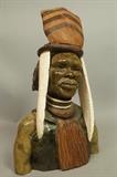 Lot 177:  P. KGAILE Carved African Bust Sculpture. Carved Stone, Wood, Ivry Bust of Warrior with Headdress. Signed.: Dimensions:  H: 12 inches: W: 8 inches: D: 5.5 inches --- 