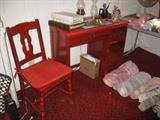 Red desk and chair, many rugs