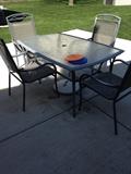 Glass top table and 4 chairs. ( No umbrella)