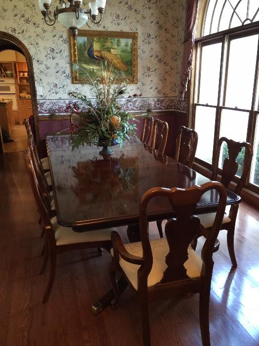  American  Drew dining table w/ 10 upholstered chairs. Table has two leafs and a custom pad.  Table is 43" wide.... 120"" long 2 leafs 24" each