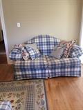 Broyhill plaid loveseat with pillows.  Cushions show wear and some stains.  Very sturdy and has a good look.