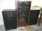 Garage:  This SANYO electronic system is sold as a unit and includes:  a pair of 28" tall speakers, 7-band analyzer, turntable, receiver, equalizer, cassette deck, CD player, and a glass door storage unit.  SOLD as single unit only.  (Additional wires are in the lower portion of the cabinet.)