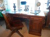 Family Room/Breezeway:  A vintage oak desk (59" wide x 29-l/2" tall x 33-l/2" deep) tagged "Buxton & Skinner Stationery-St. Louis;" antique oak office chair from Lammert's;  green glass shade banker's lamp; and miscellaneous décor.  