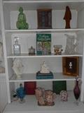 Living Room:  The bookcase on the right has more decorative items including glassware, crystal, figures, and chintz.