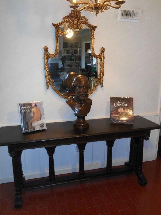 Entry Foyer:  Antique library table measures 72" wide x 30" tall x 28" deep and has a BID on it.   The shield-design mirror SOLD.  A better view of the bronze bust is coming up! 
