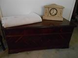 Bedroom #3:  A cedar hope chest; vintage bedspread with "M.P." monogrammed on it and a shabby chic mantel clock.