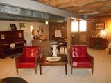 Lower Level:  Two red vintage chairs and a LANE square coffee table.