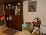 Lower Level:  Two tall narrow bookcases; artwork; rugs; vintage wooden high chair.  