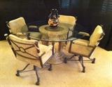 Glass-top dinette with 4 rolling chairs