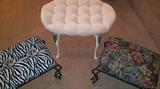 Wrought iron vanity stool in the middle and 2 foot stools