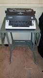 Olympia Report DeLuxe electric typewrite on metal rolling double-drop side table