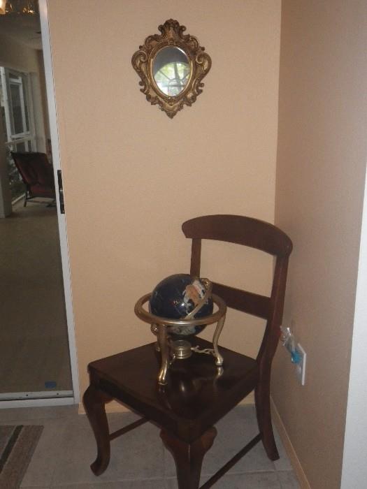 Small mirror, globe and one of the dining room table chairs