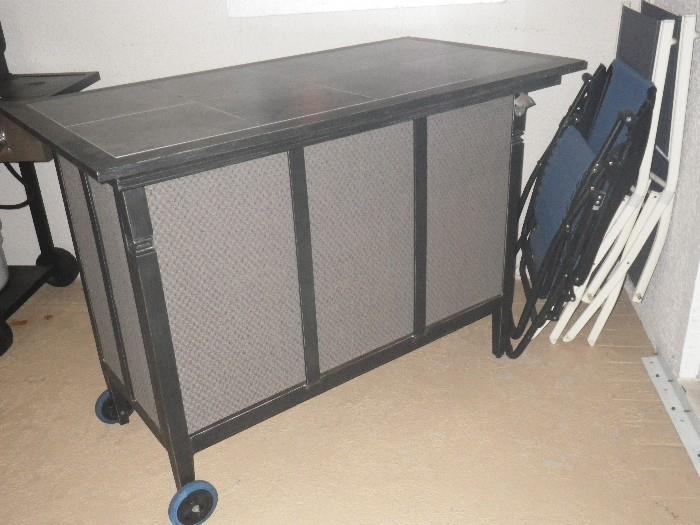 Metal bar with tile top. Wheels have been added for ease of movement while entertaining