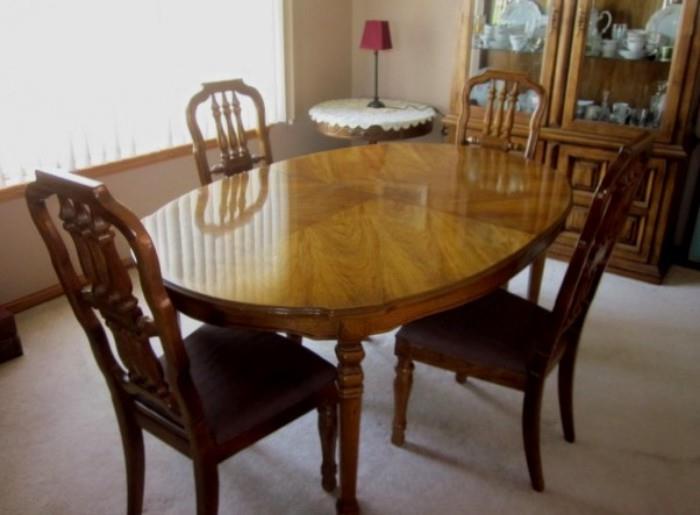 Solid wood oval dining table with two leaves by Thomasville